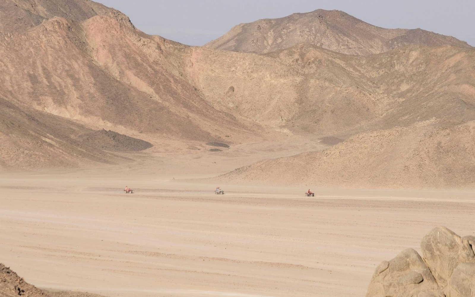 a desert landscape with mountains in the background