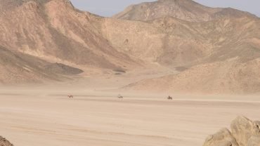 a desert landscape with mountains in the background