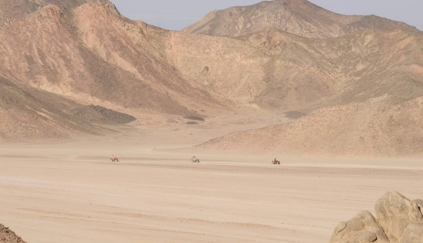 a desert landscape with mountains in the background