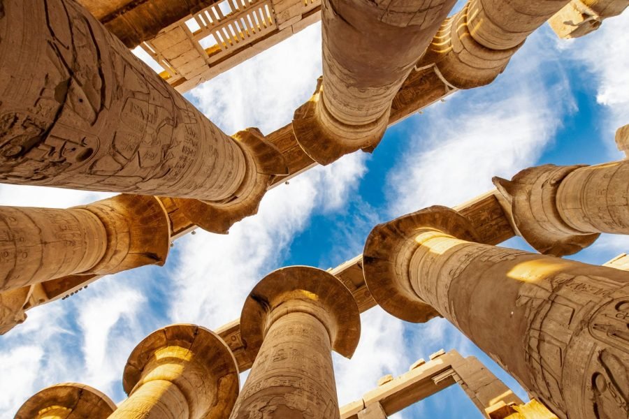 low angle photography of brown concrete building under blue sky during daytime